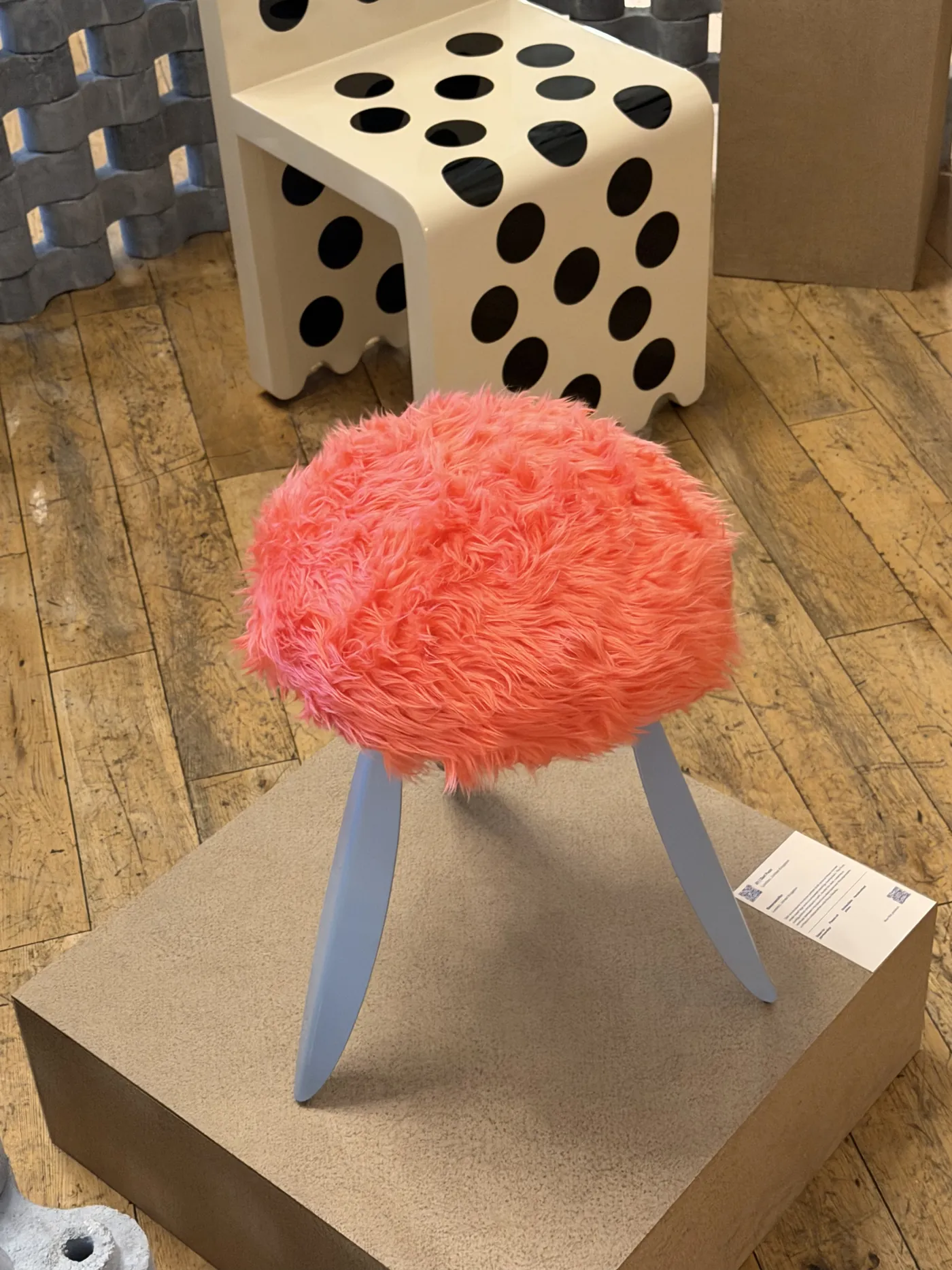 DOT Fuzz up close — a coral fur seat on pale blue legs