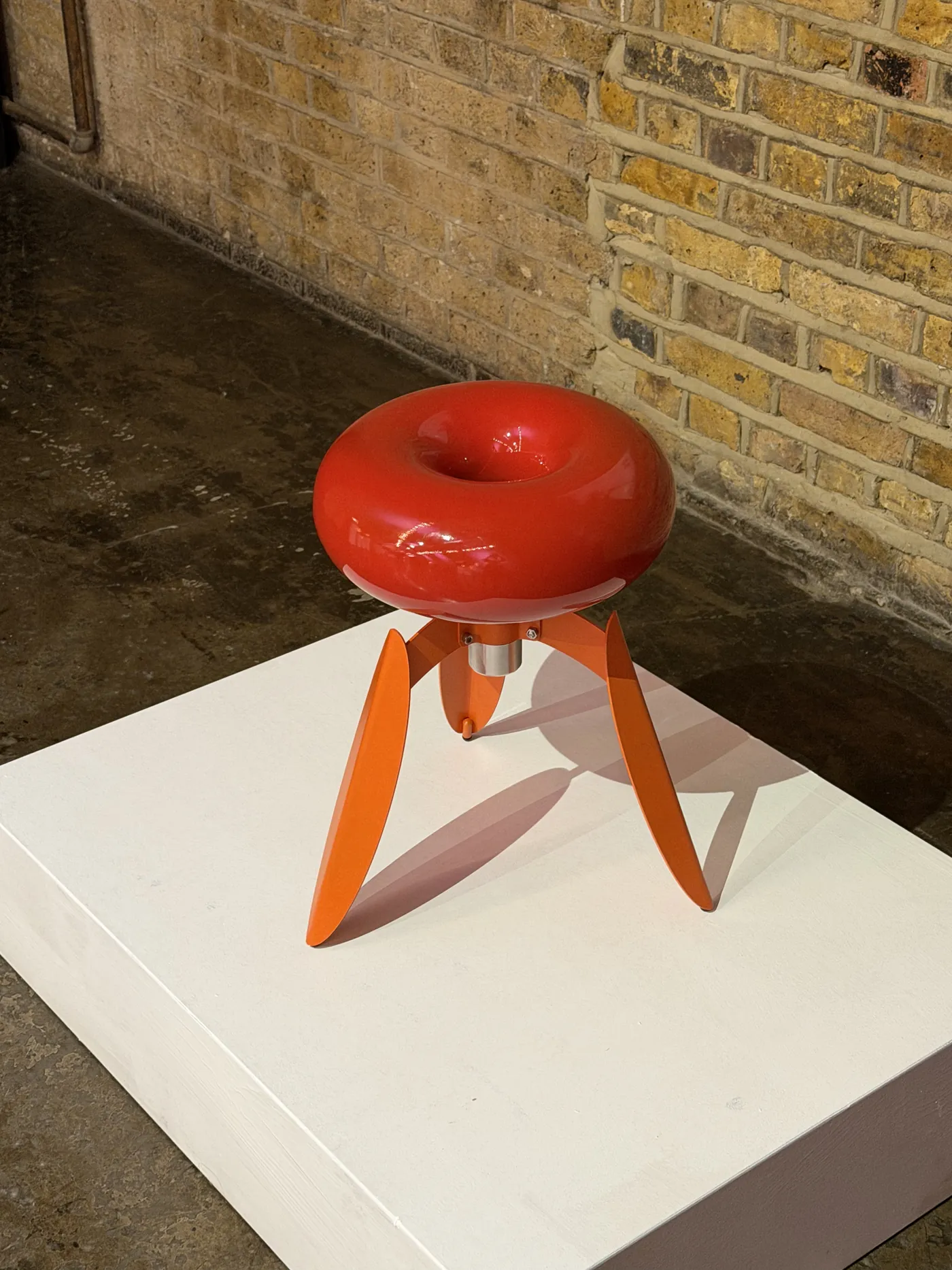 DOT Nut from three-quarter view on its white plinth