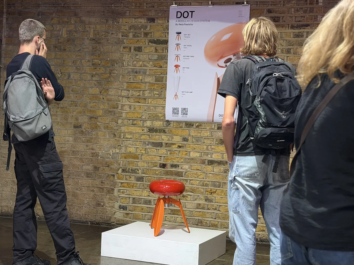 Visitors stopping at DOT Nut beneath the DOT system poster