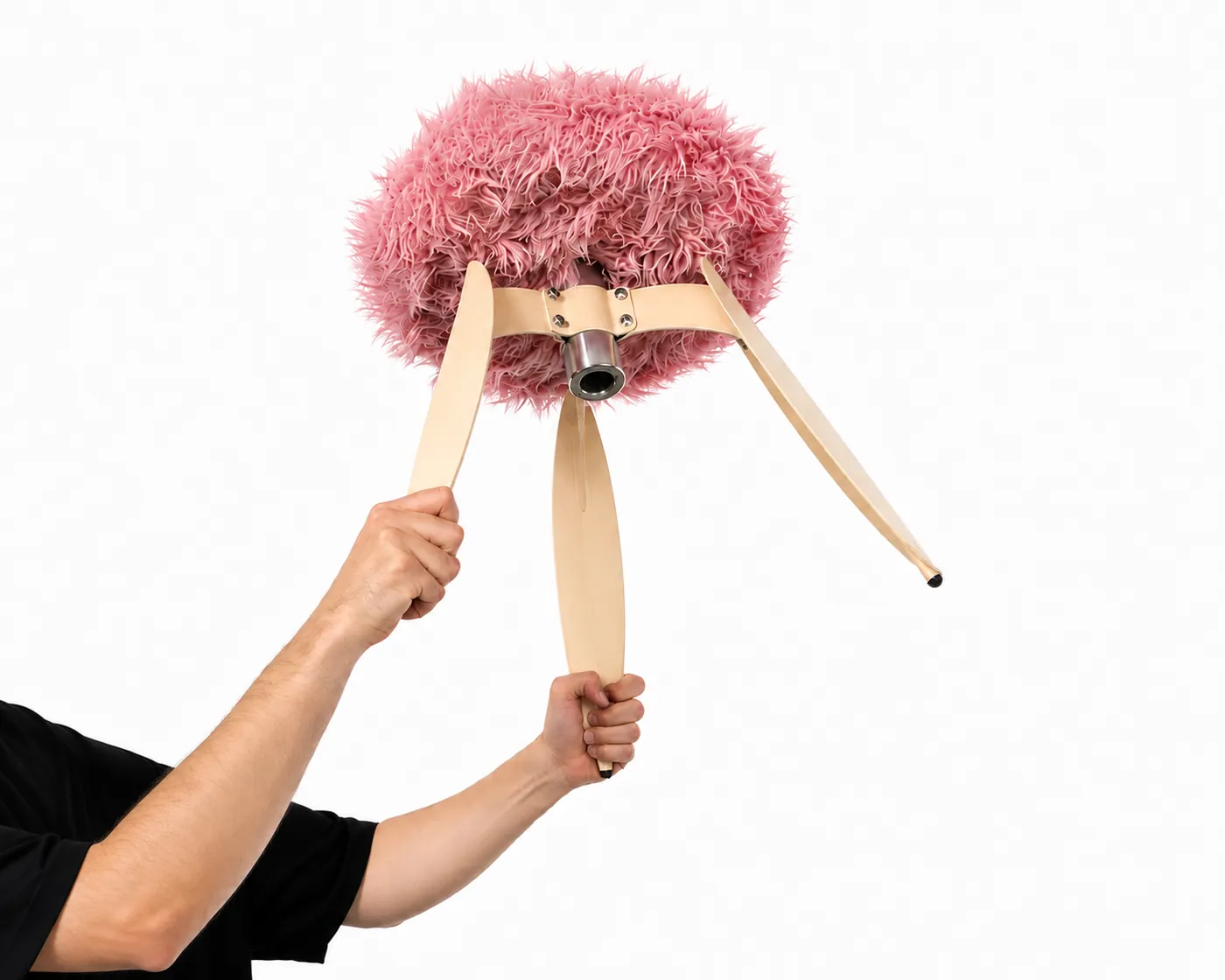 The fur stool held upside down, showing how the legs meet the seat