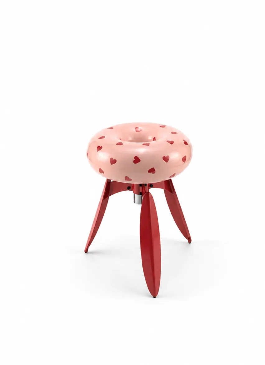 The heart-printed limited edition — a pale pink ring seat on deep red legs