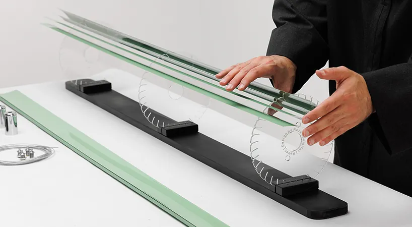 Threading the cut slats into the grooves of the laser-cut acrylic discs