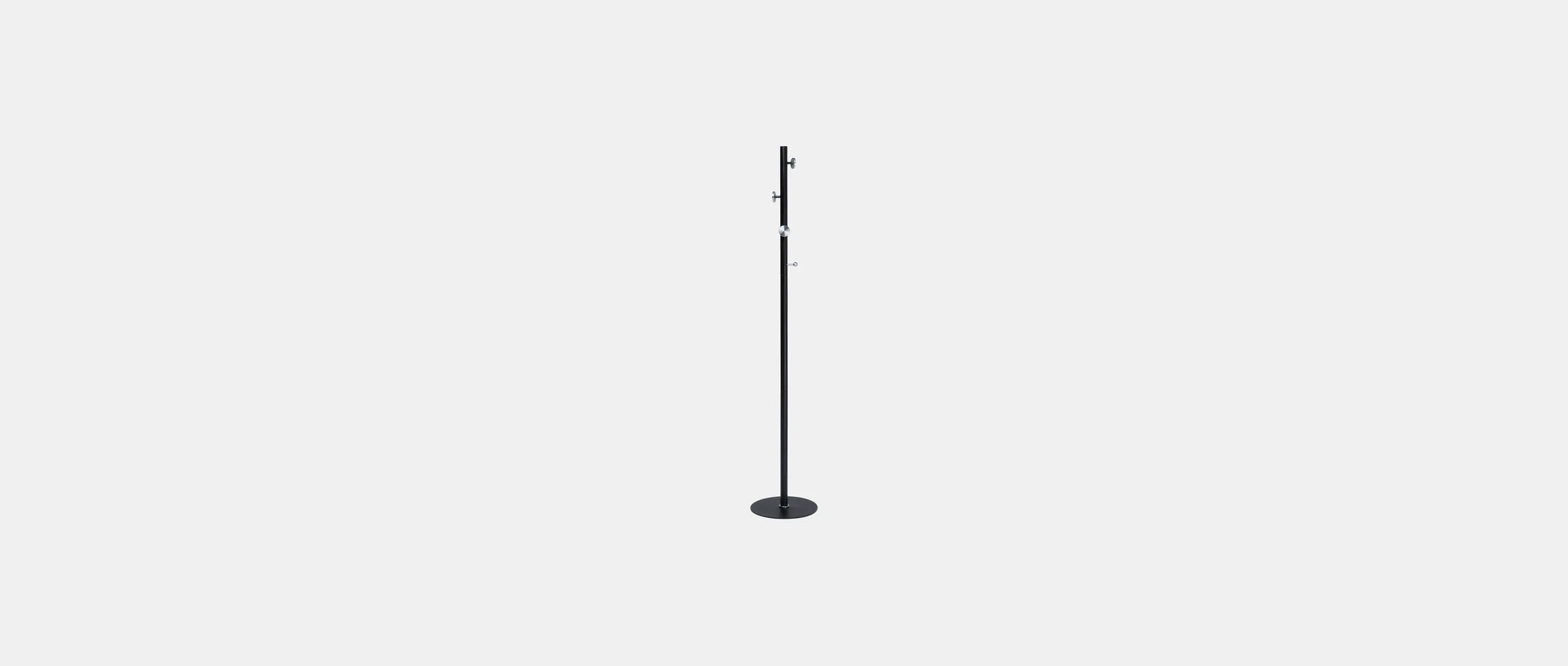 The Zero & One coat rack standing alone — a black stem with disc hooks